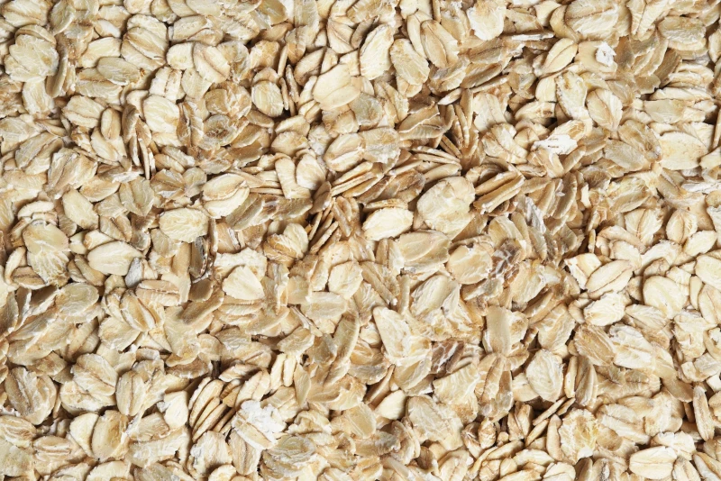 Close-up of oatmeal flakes, tightly packed and covering the entire image surface